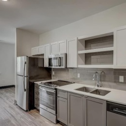 kitchen with ample counter-space, modern appliances and bright lighting